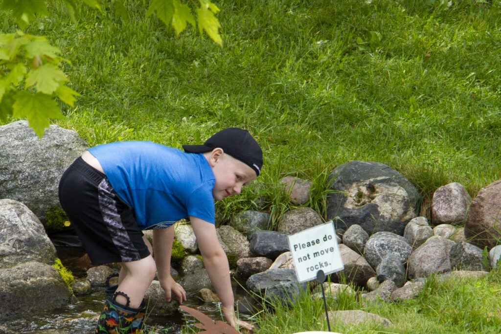 child playing in stream